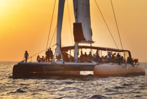 Ocean Voyager Holiday-Cat sailing in the sunset with customers